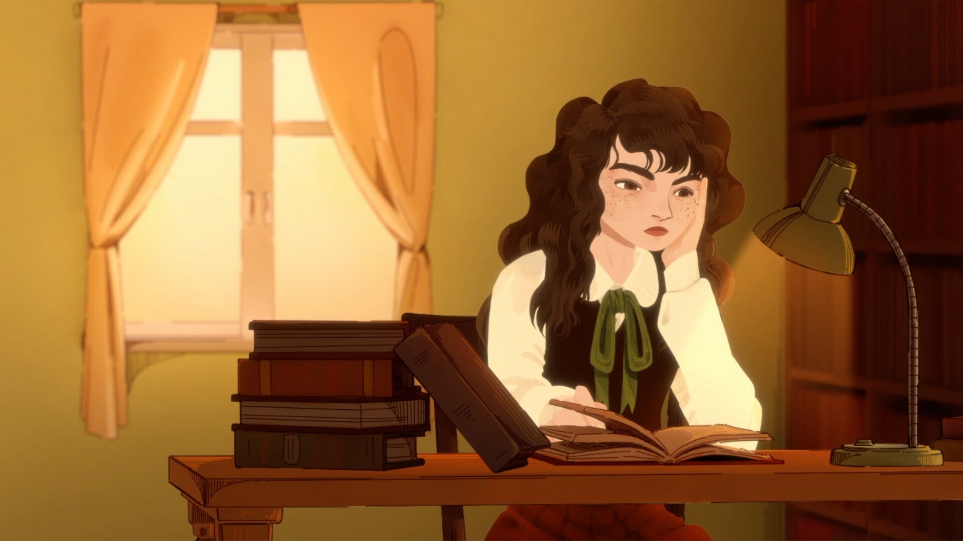 Elena reading a book at a desk by the window